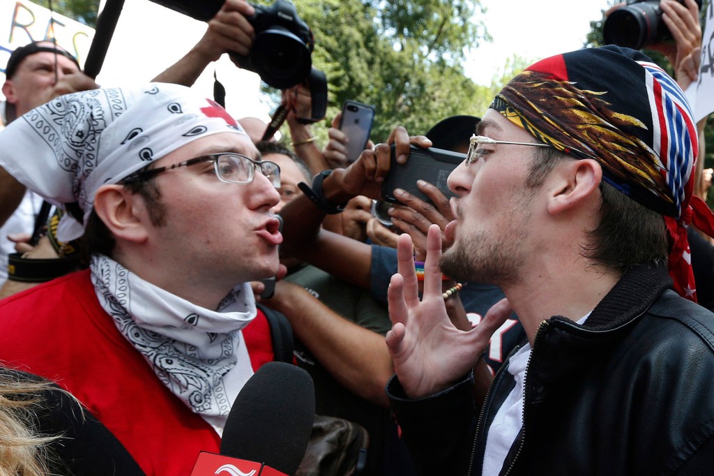 A counterprotester confronts a supporter of President Donald Trump at a "Free Speech" rally in Boston on August 19